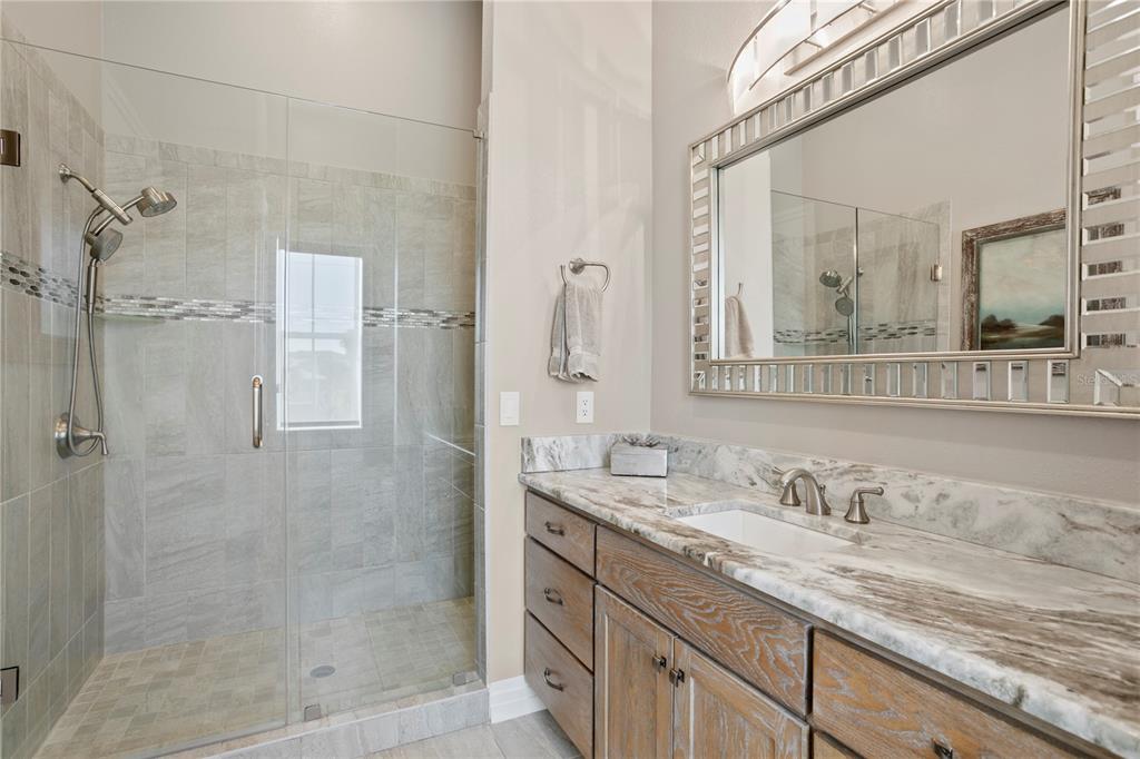 15612 Gulf Boulevard Redington Beach, FL 33708 - Photo 46 of 92 a bathroom with a granite countertop sink mirror and double