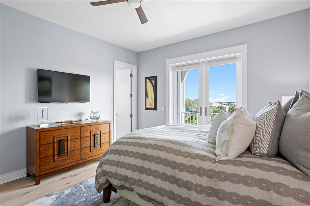 15612 Gulf Boulevard Redington Beach, FL 33708 - Photo 49 of 92 a spacious bedroom with a bed and a flat screen tv