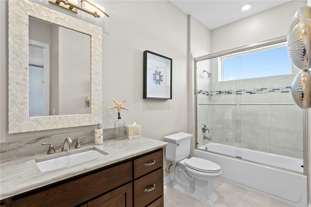 15612 Gulf Boulevard Redington Beach, FL 33708 - Photo 53 of 92 a bathroom with a granite countertop sink toilet and shower