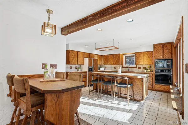 a kitchen with a table chairs and a stove