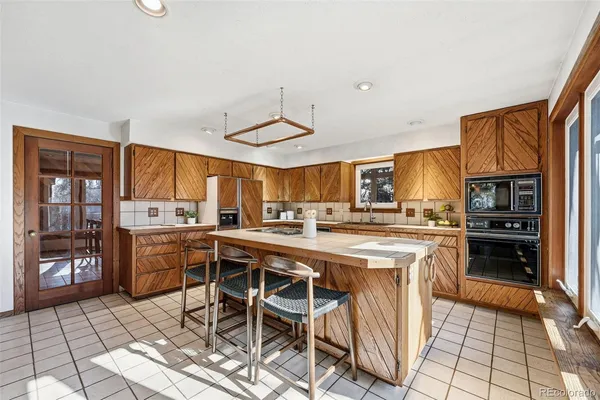 a kitchen with a stove a sink and cabinets