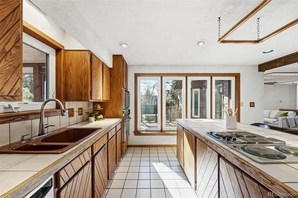 a kitchen with a sink stove and cabinets