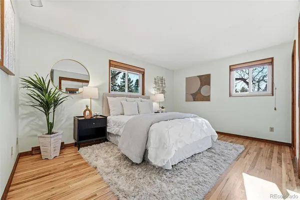 a bedroom with a large bed and a painting on the wall
