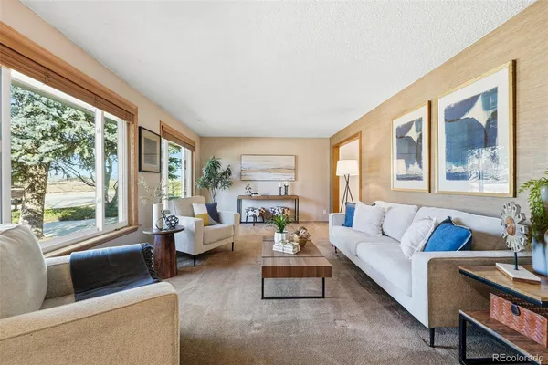 a living room with furniture and a large window