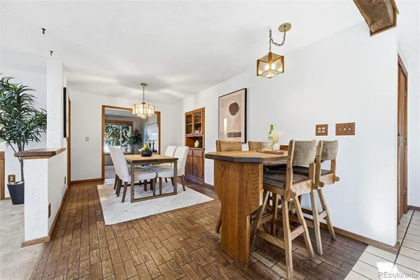 a view of a dining room with furniture and a potted plant