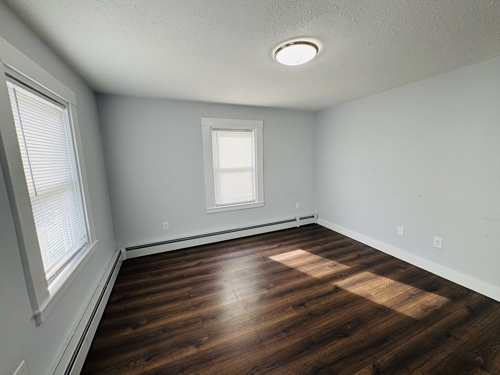48 South Bow Street, Unit 1 Milford, MA 01757 - Photo 4 of 5 a view of empty room with wooden floor and fan