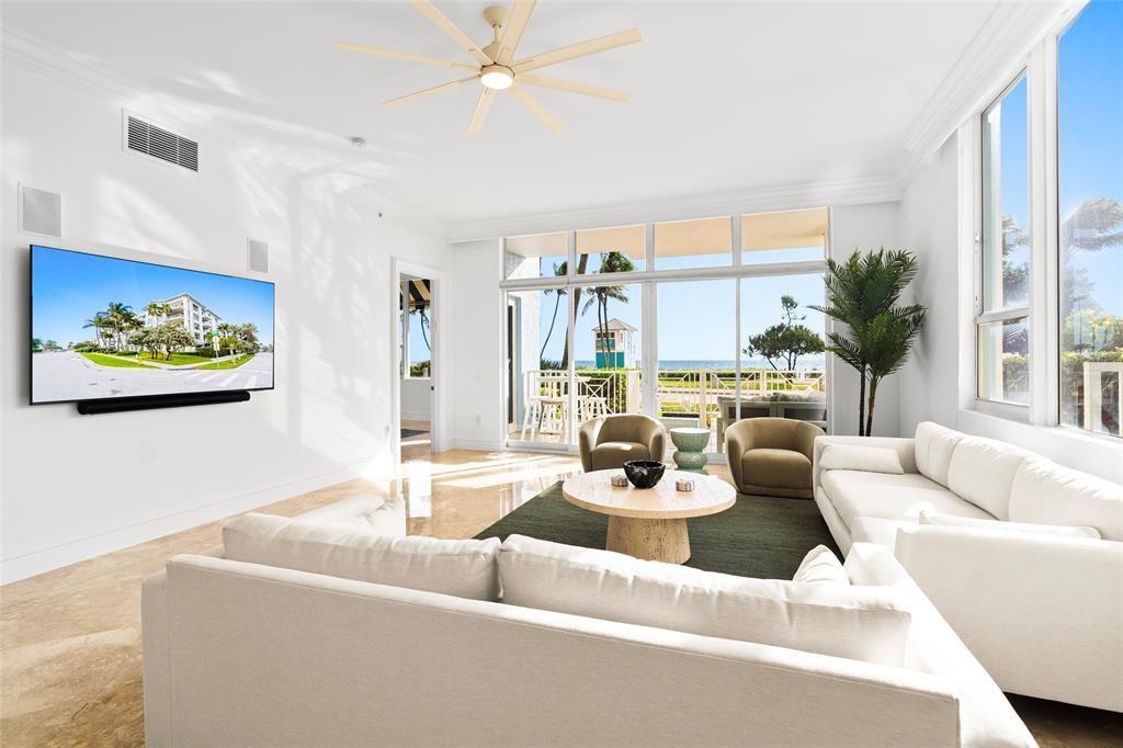 701 Southeast 21st Avenue, Unit 109 Deerfield Beach, FL 33441 - Photo 1 of 34 a living room with furniture and a large window