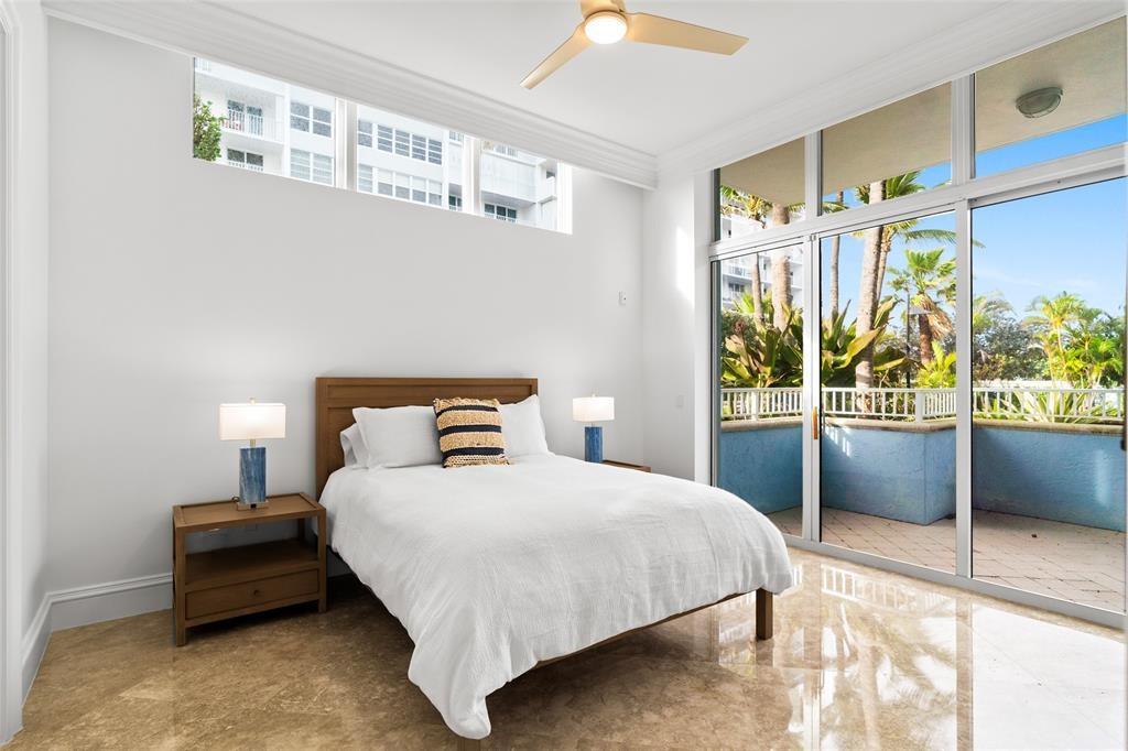 701 Southeast 21st Avenue, Unit 109 Deerfield Beach, FL 33441 - Photo 15 of 34 a bedroom with a bed and a large window