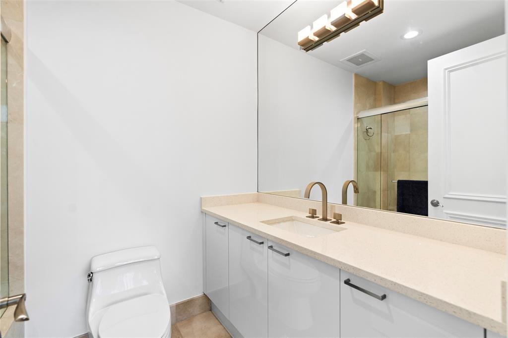701 Southeast 21st Avenue, Unit 109 Deerfield Beach, FL 33441 - Photo 19 of 34 a bathroom with a sink a toilet and mirror