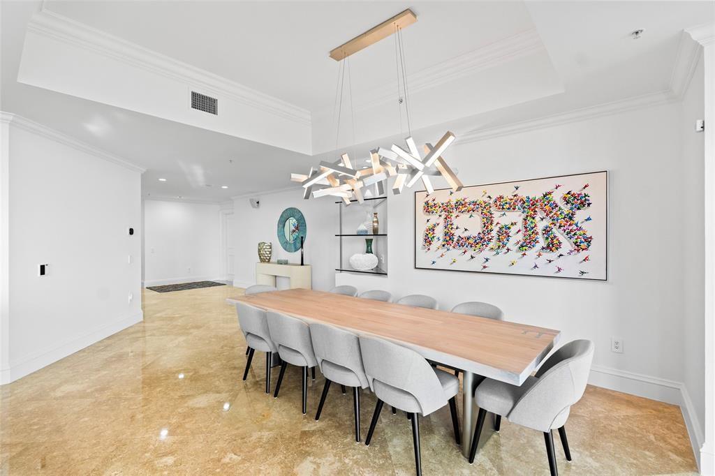 701 Southeast 21st Avenue, Unit 109 Deerfield Beach, FL 33441 - Photo 2 of 34 a dining room with a table and chairs
