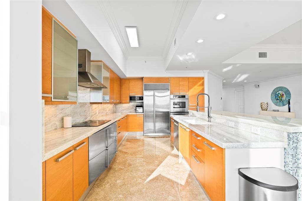 701 Southeast 21st Avenue, Unit 109 Deerfield Beach, FL 33441 - Photo 4 of 34 a large kitchen with stainless steel appliances lots of counter space and a sink