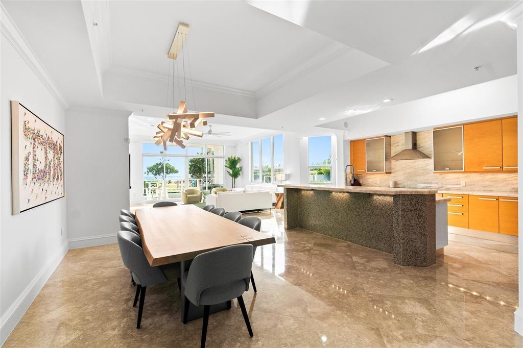 701 Southeast 21st Avenue, Unit 109 Deerfield Beach, FL 33441 - Photo 5 of 34 a kitchen with a table and chairs in it
