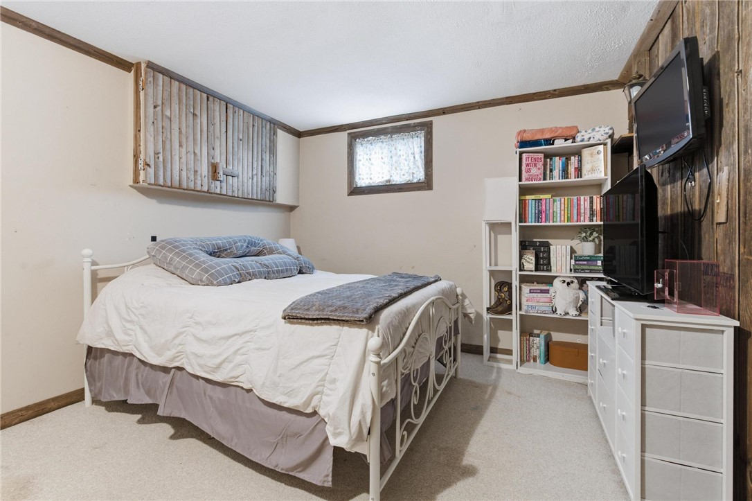 8747 Waynes Way Blanchester, OH 45107 - Photo 23 of 40 This cozy bedroom offers a tranquil retreat with soft lighting and ample space for relaxation.
