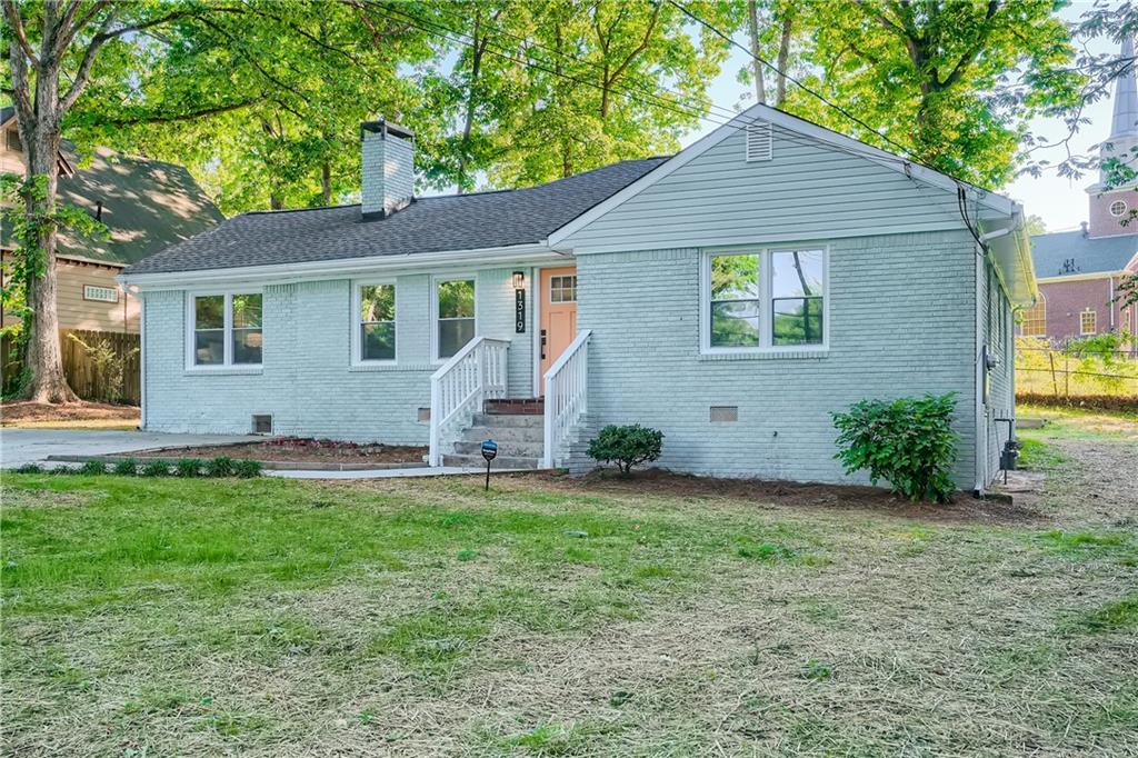1319 Peachcrest Road Decatur, GA 30032 - Photo 1 of 1 a front view of a house with a yard and garage