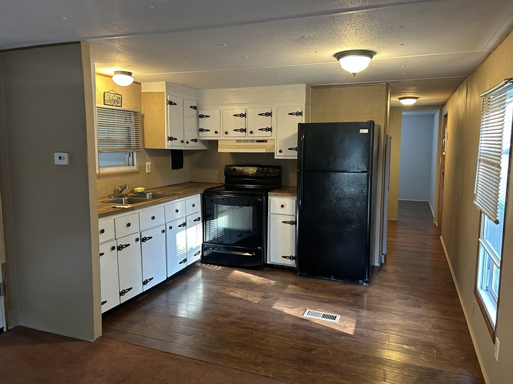 189 Springfield Road, Unit 10 Westfield, MA 01085 - Photo 3 of 8 a kitchen with granite countertop a refrigerator and a sink