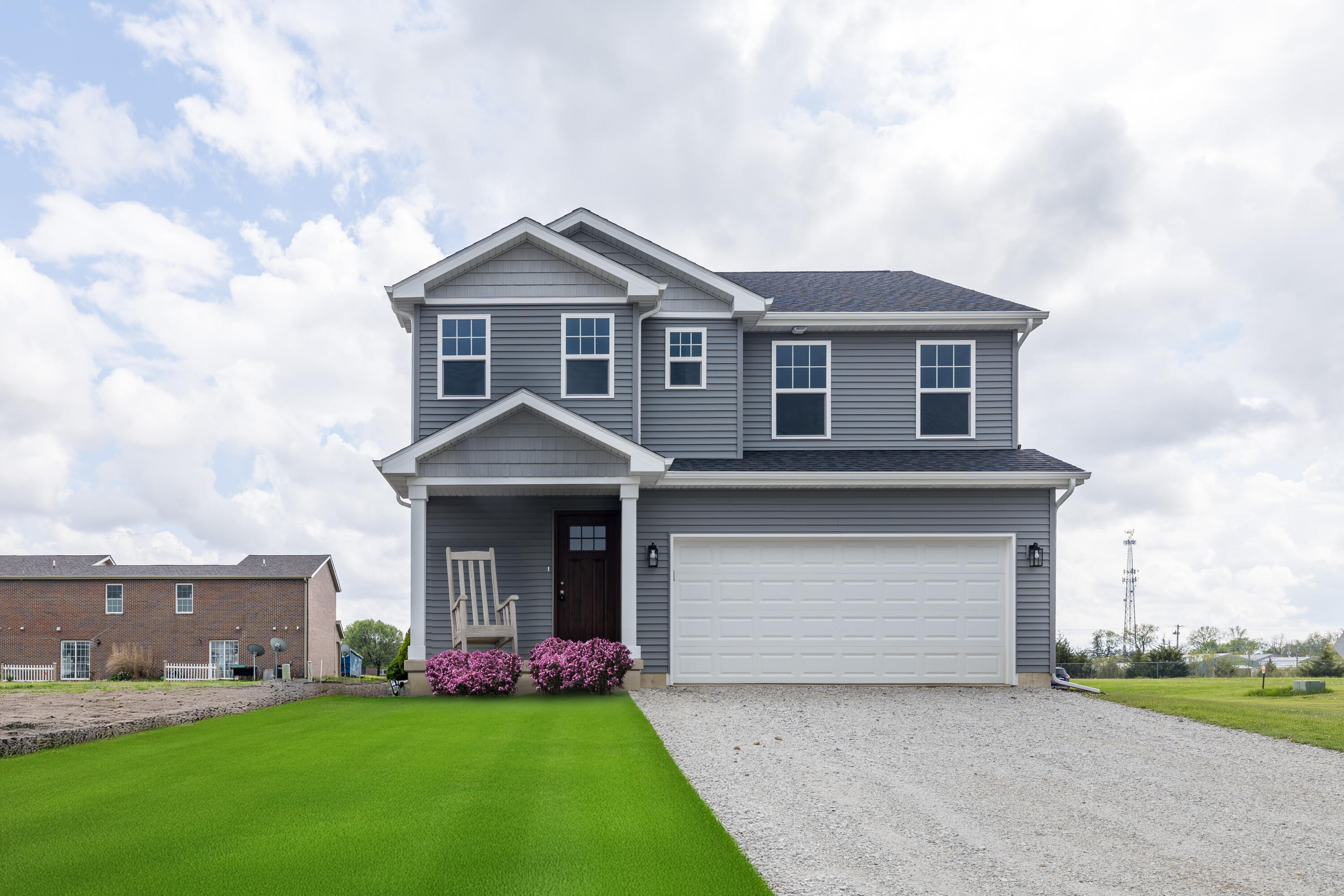 a front view of a house with a garden and yard