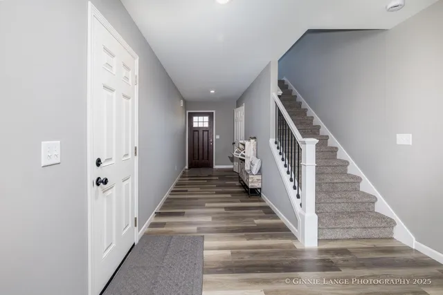a view of staircase with lots of frames and a rug