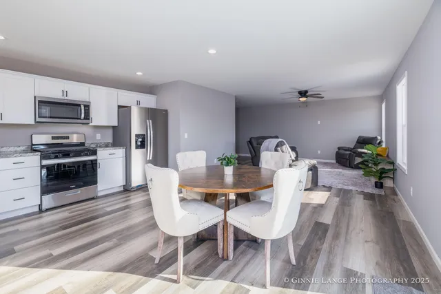 a view of a dining room with furniture and wooden floor