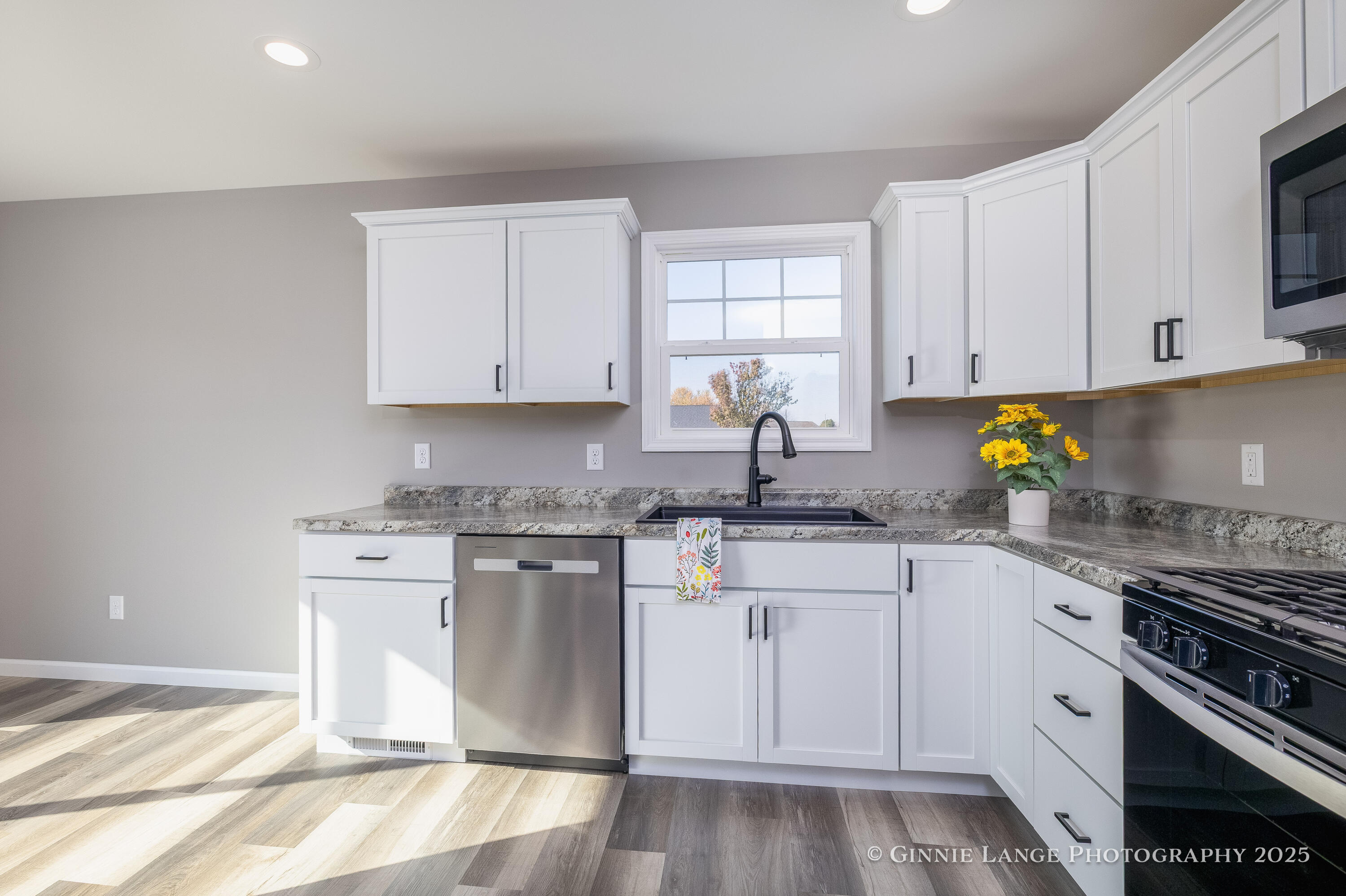 403 Wolf Street Rensselaer, IN 47978 - Photo 17 of 38 a kitchen with granite countertop a stove sink and cabinets