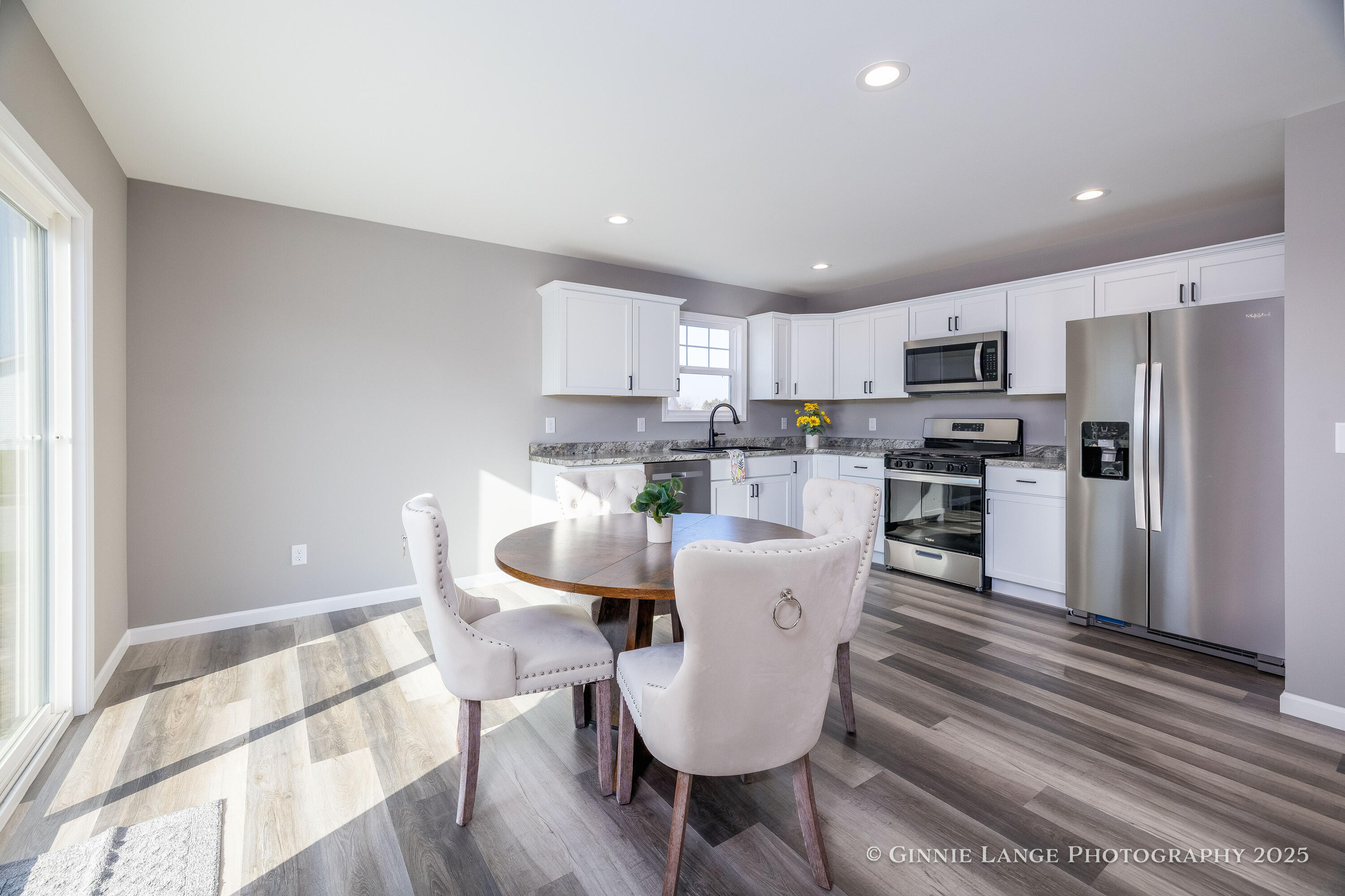 403 Wolf Street Rensselaer, IN 47978 - Photo 19 of 38 a living room with stainless steel appliances a dining table wooden floor and a view of kitchen