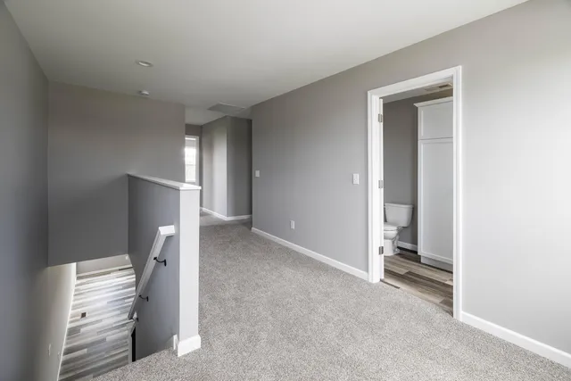 a view of an empty room with a fireplace