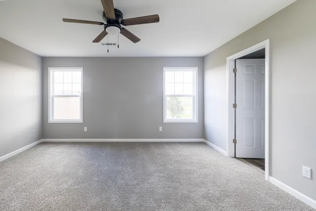a view of a livingroom with a ceiling fan and window