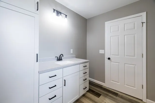 a bathroom with a sink a mirror and a shower