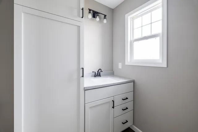 a room with a window and a ceiling fan