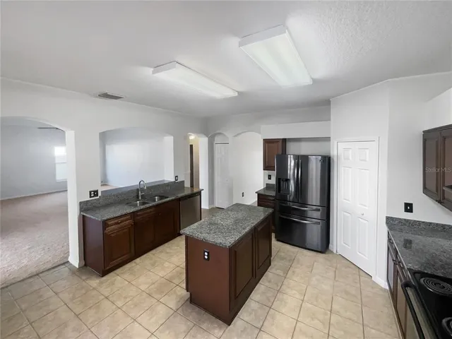 a kitchen with stainless steel appliances granite countertop a stove and a refrigerator