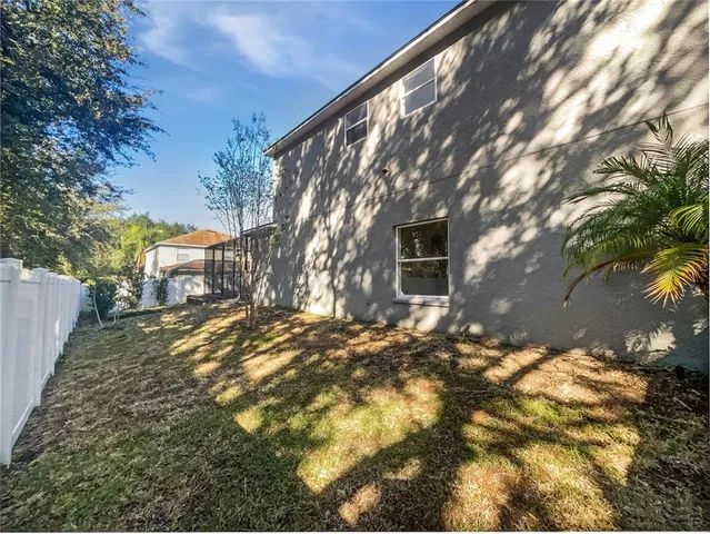 a view of a yard with plants and trees