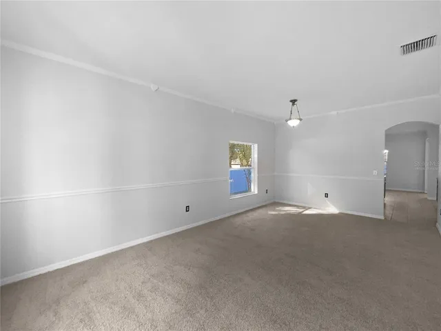 an empty room with a empty space and windows