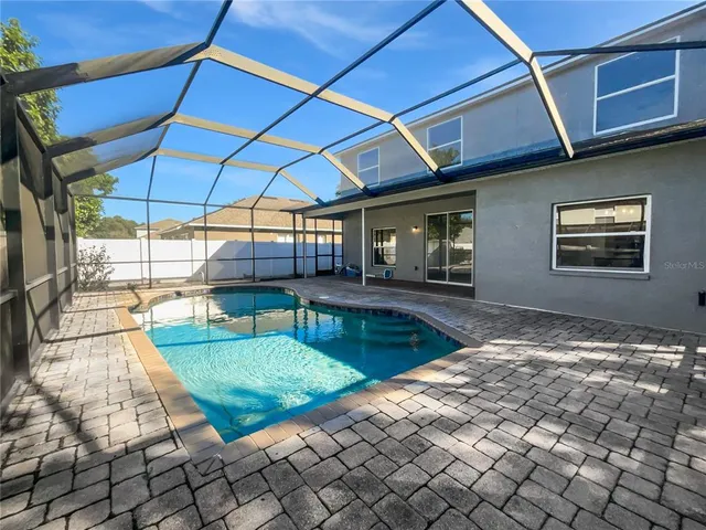 a backyard of a house with yard and outdoor seating