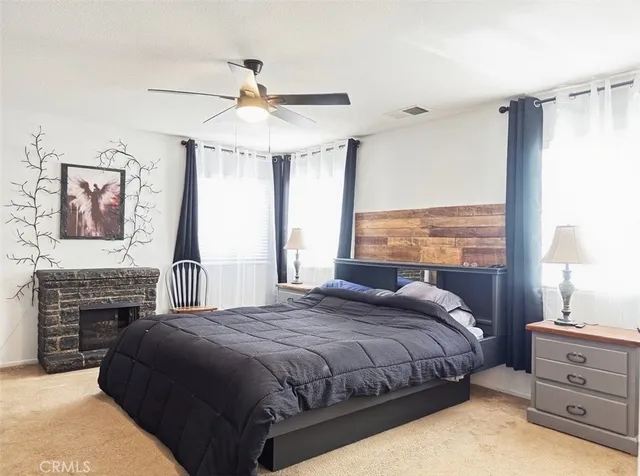 a bedroom with a bed and a fireplace