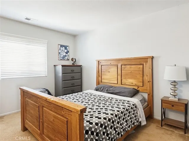 a bedroom with a bed and a dresser