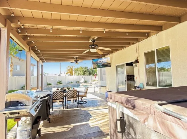 a view of a patio with table and chairs
