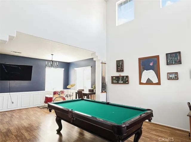 a room with pool table and windows