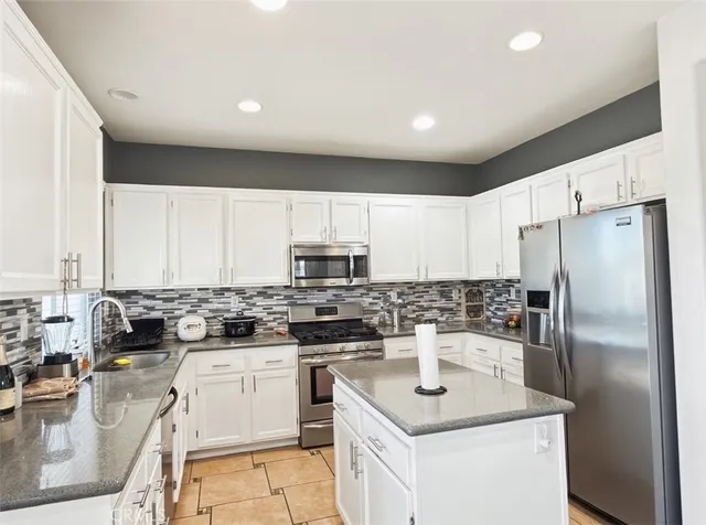a kitchen with a sink stove and refrigerator