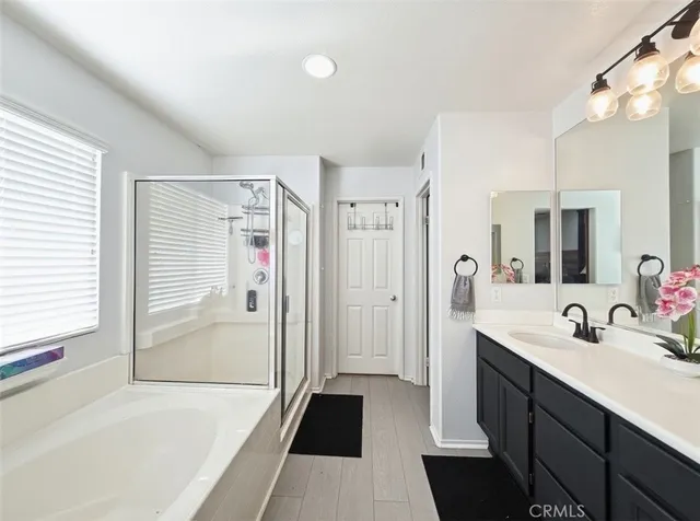 a bathroom with a sink a mirror and a shower