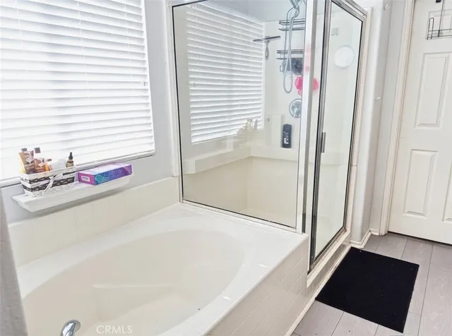 a bathroom with a tub and shower