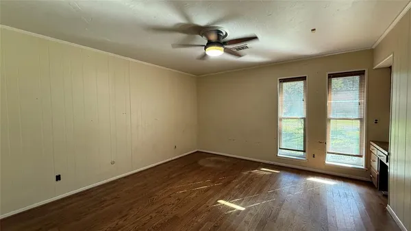 a view of an empty room with window and fireplace
