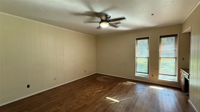 a view of an empty room with window and fireplace