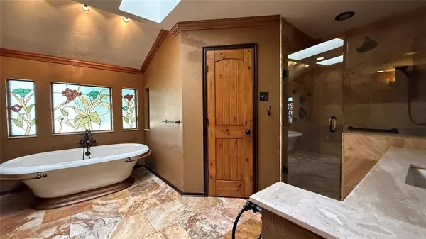 a view of an empty room with wooden floor fireplace and a window