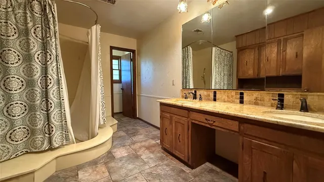 a view of empty room with wooden floor and window