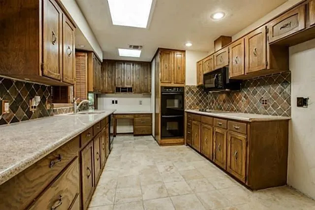a kitchen with stainless steel appliances a sink and cabinets