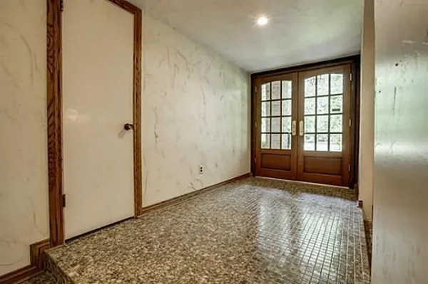 a view of an empty room with a fireplace