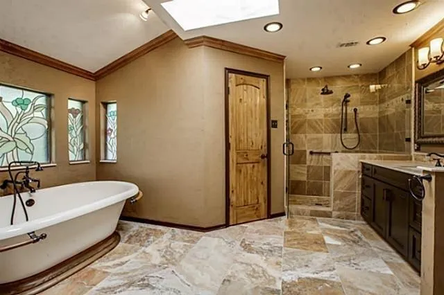 a spacious bathroom with a tub and a sink