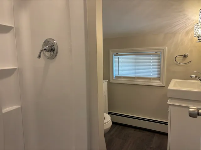 a bathroom with a granite countertop sink and mirror