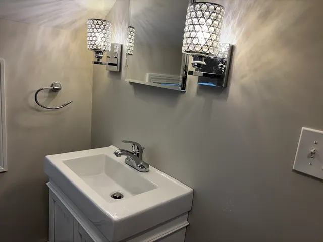 a bathroom with a sink and a window