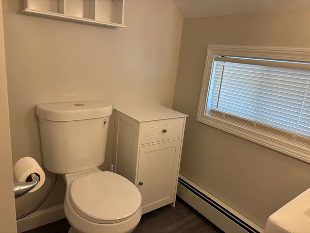 a white toilet sitting next to a window