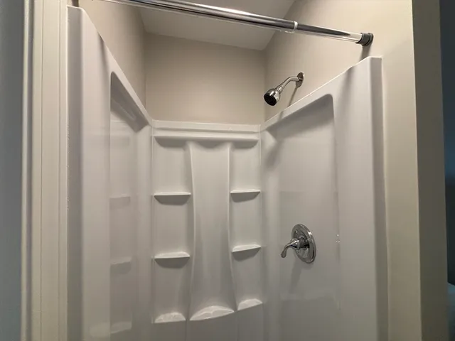 a bathroom with a glass shower door